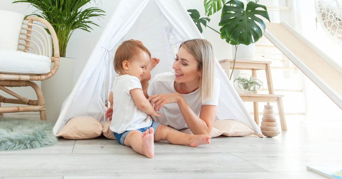 Mom and baby playing and relaxing in a cozy room with eco-friendly, sustainable materials, creating a calm and nurturing home environment.