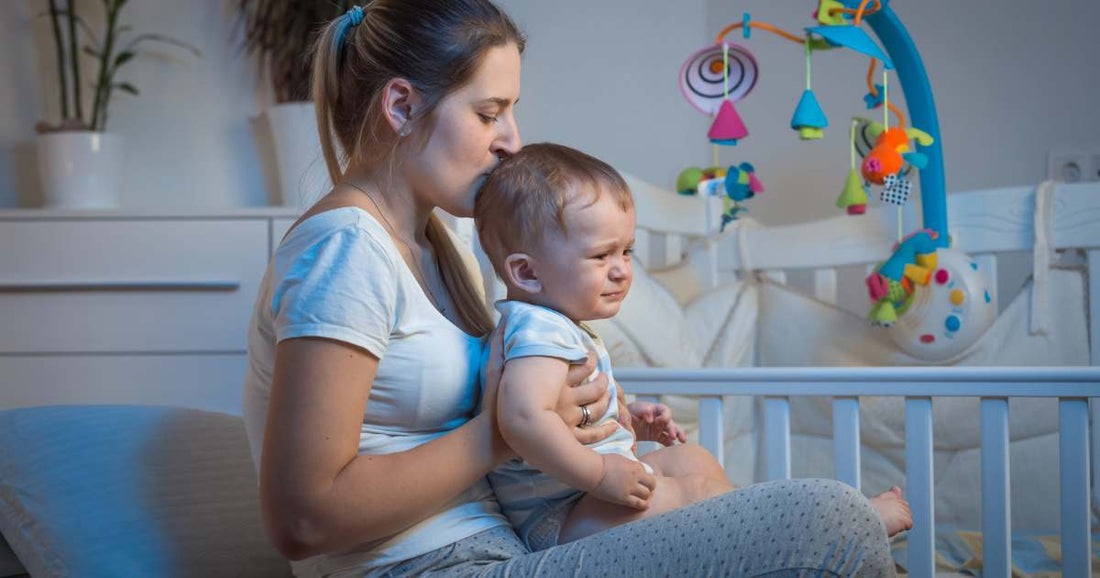 Mother soothing her baby back to sleep after waking up in the middle of the night in a calm, dimly lit nursery.