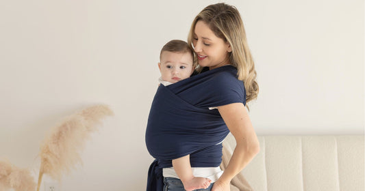 Mom babywearing baby during a calm, slow bonding moment.
