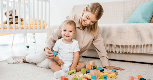 Mom and baby enjoying playtime in a comfortable nursery room with organized baby essentials.