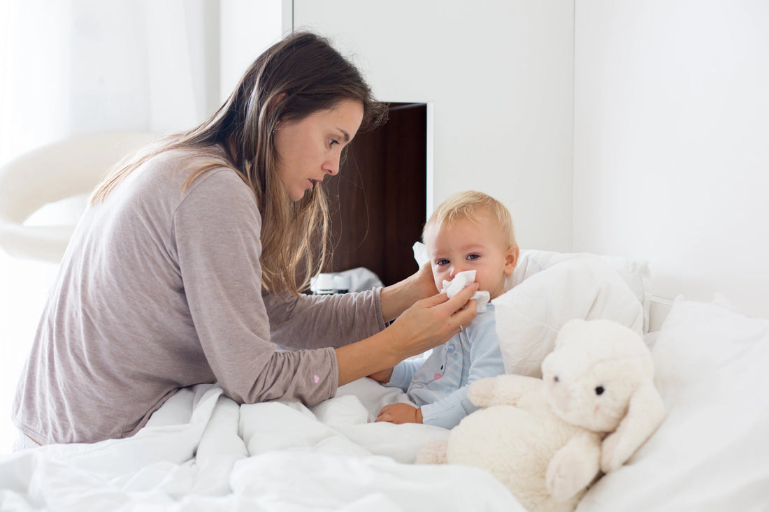 Mother caring for her congested, cold-stricken baby in cozy morning pajamas.